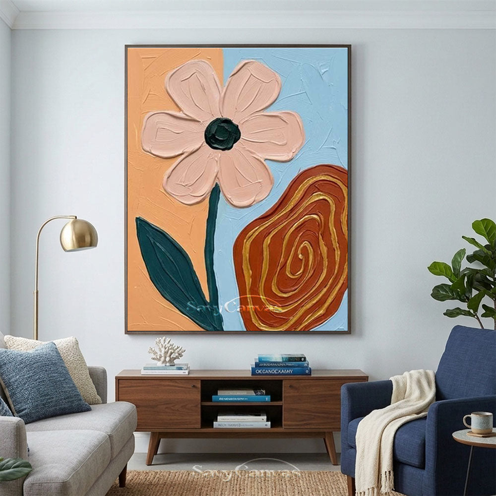 Hand-painted abstract oil painting showcasing a thick-textured pink flower on an orange and blue background next to a brown swirl with gold lines, styled in a cozy modern apartment living room