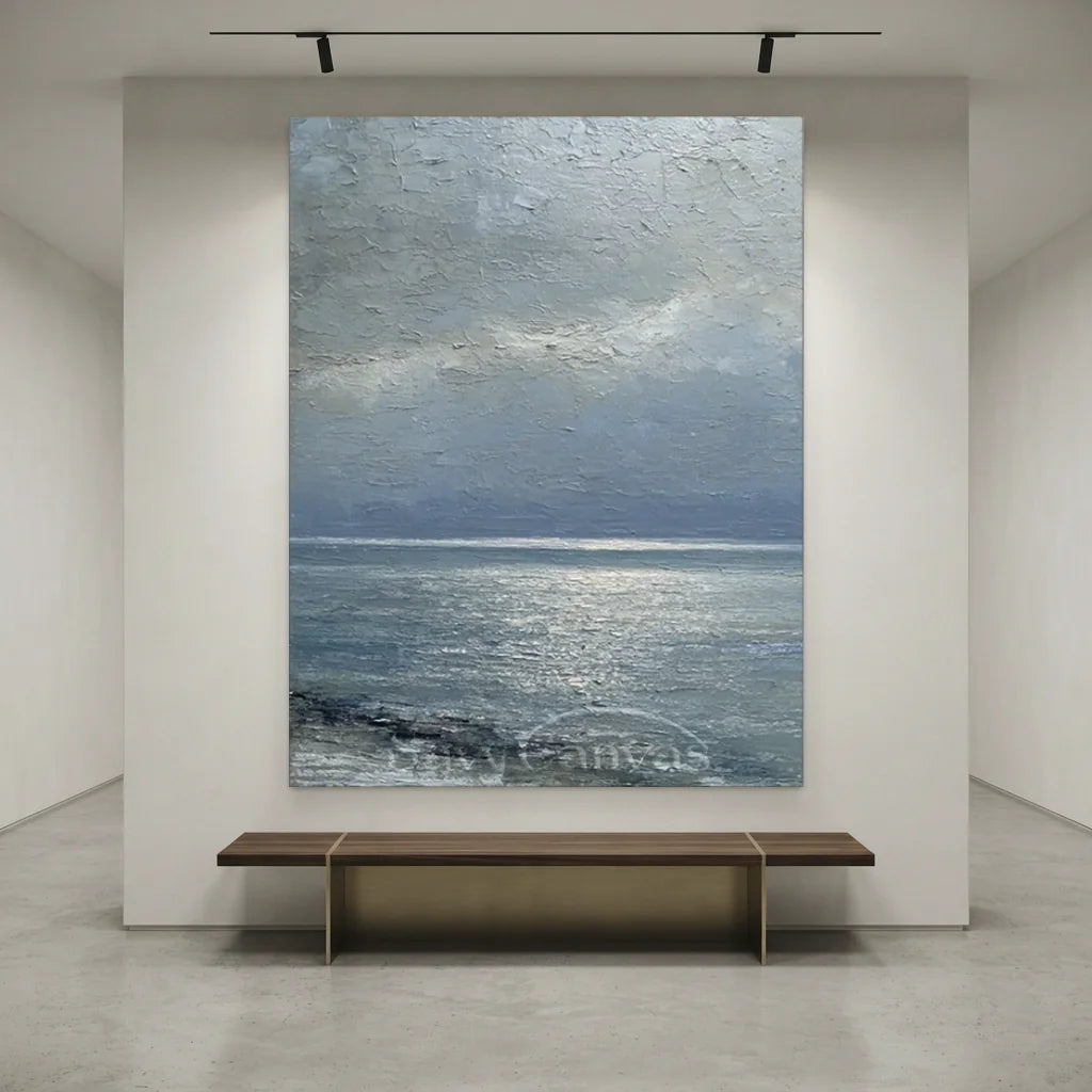 Handmade impressionist grey seascape oil painting featuring silver light breaking through misty grey clouds onto a calm sea, rendered with heavy impasto texture on canvas for modern living room decor.