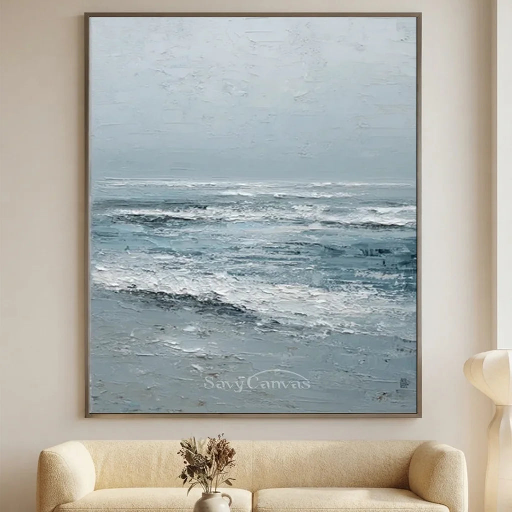 Handmade 3D textured ocean wave oil painting featuring crashing white foam crests and slate blue water created with heavy palette knife impasto brushwork on canvas for modern living room decor.
