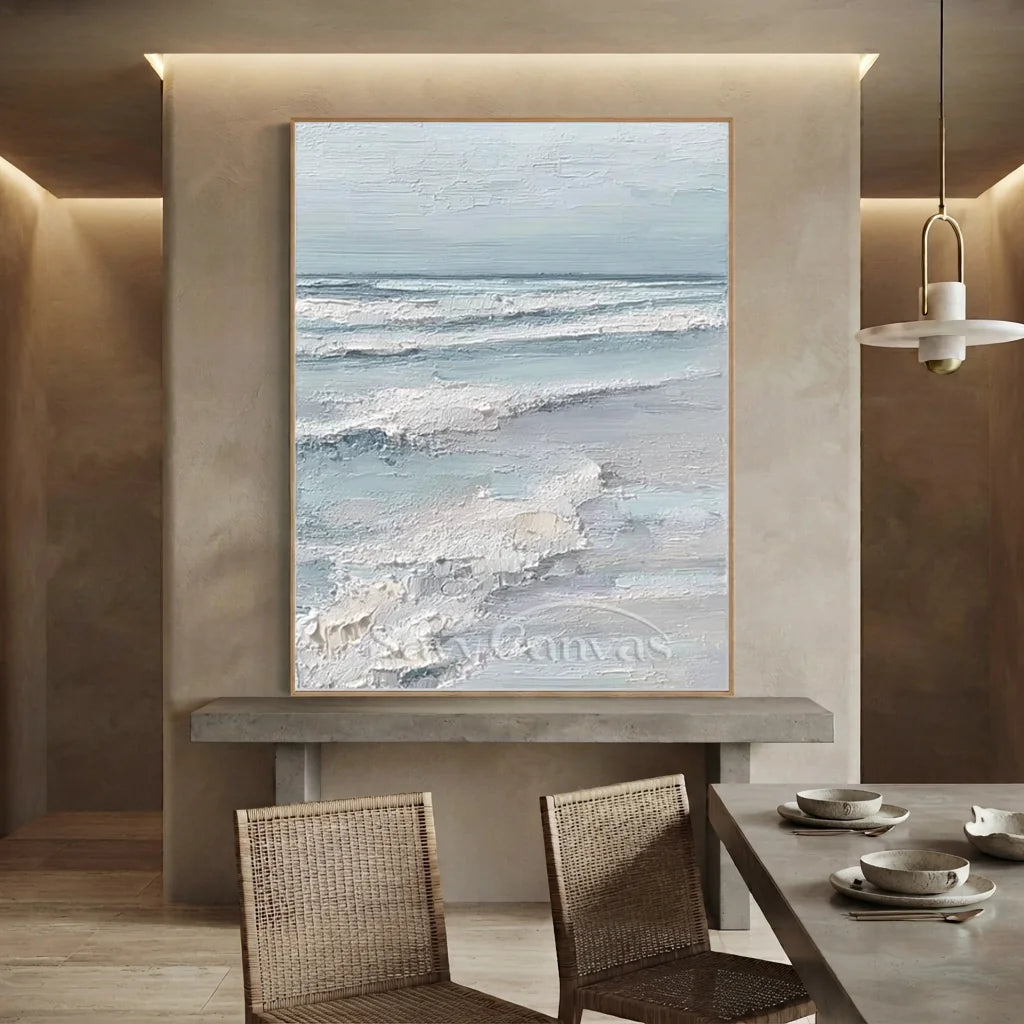 Handmade 3D textured soft blue ocean wave oil painting depicting frothy white foam crests crashing over pastel blue waters, rendered with heavy impasto palette knife brushwork on canvas for modern living room decor.