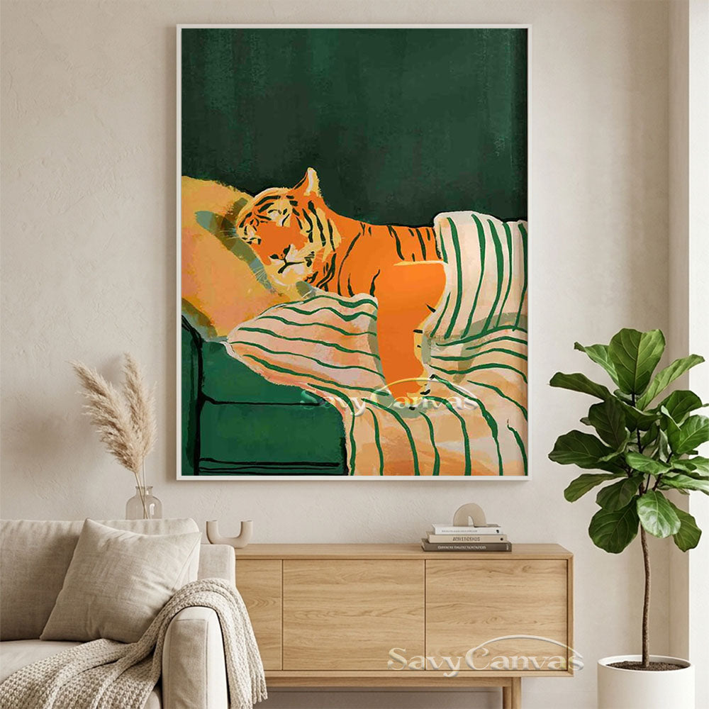 Hand-painted whimsical retro oil painting of a vivid orange tiger sleeping in a bed under a green and white striped blanket, styled above a wooden console table in a beige living room.